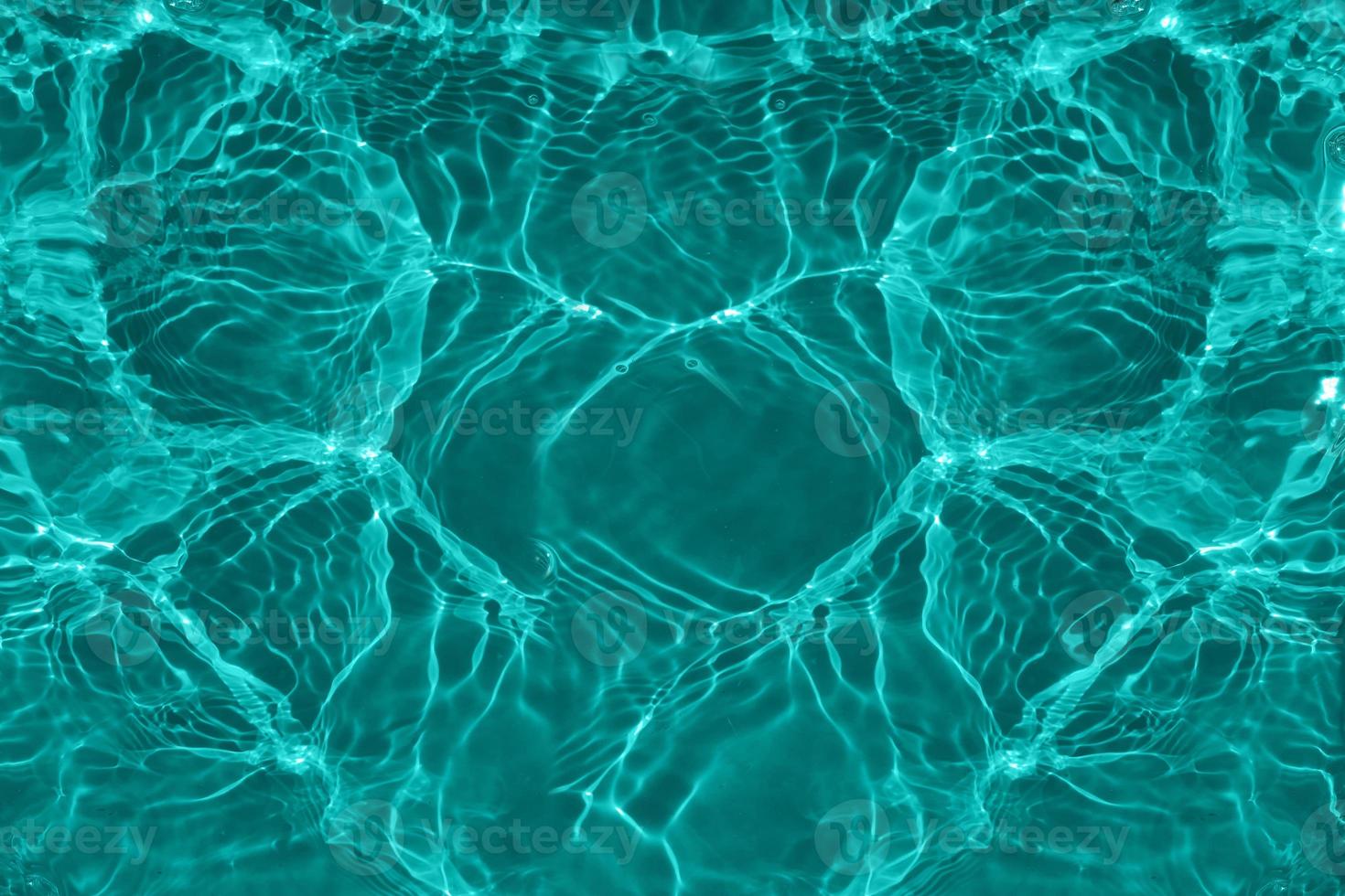 Defocus blurred transparent blue colored clear calm water surface texture with splashes and bubbles. Trendy abstract nature background. Water waves in sunlight with copy space. Blue watercolor shining photo