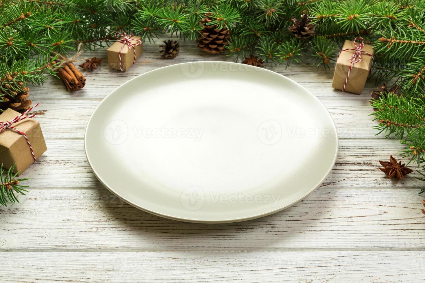 Perspective view. Empty plate round ceramic on wooden christmas background. holiday dinner dish concept with new year decor photo