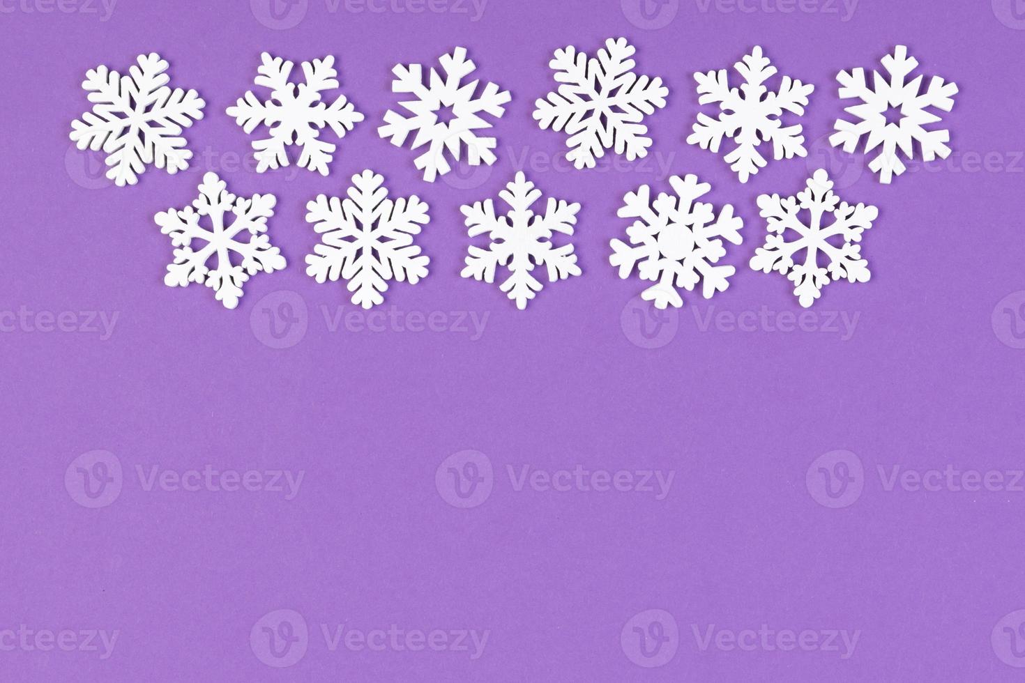 Set of white snowflakes on colorful background. Top view of Christmas ornament. New Year time concept with empty space for your design photo