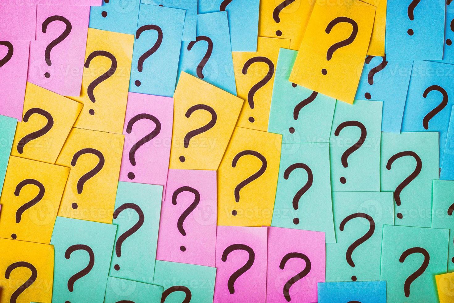 Question marks background. Colorful paper notes with question marks. Concept image. Closeup top view toned photo