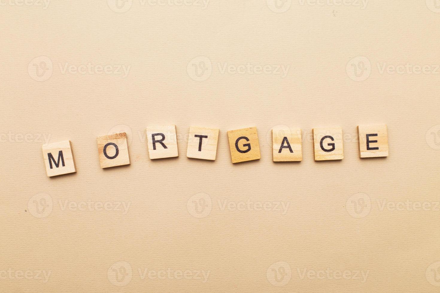 inscription mortgage on a beige background made by wooden blocks photo