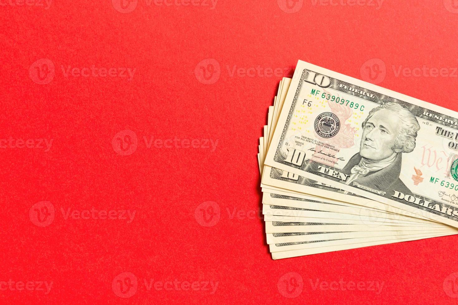 Top view of bundle of 10 dollar bill on colorful backgound. Business concept with copy space photo