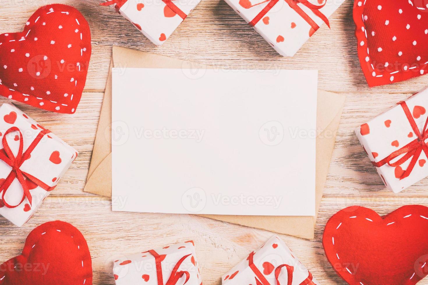 Envelope Mail with Red Heart and gift box over Orange Wooden Background. Valentine Day Card, Love or Wedding Greeting Concept photo