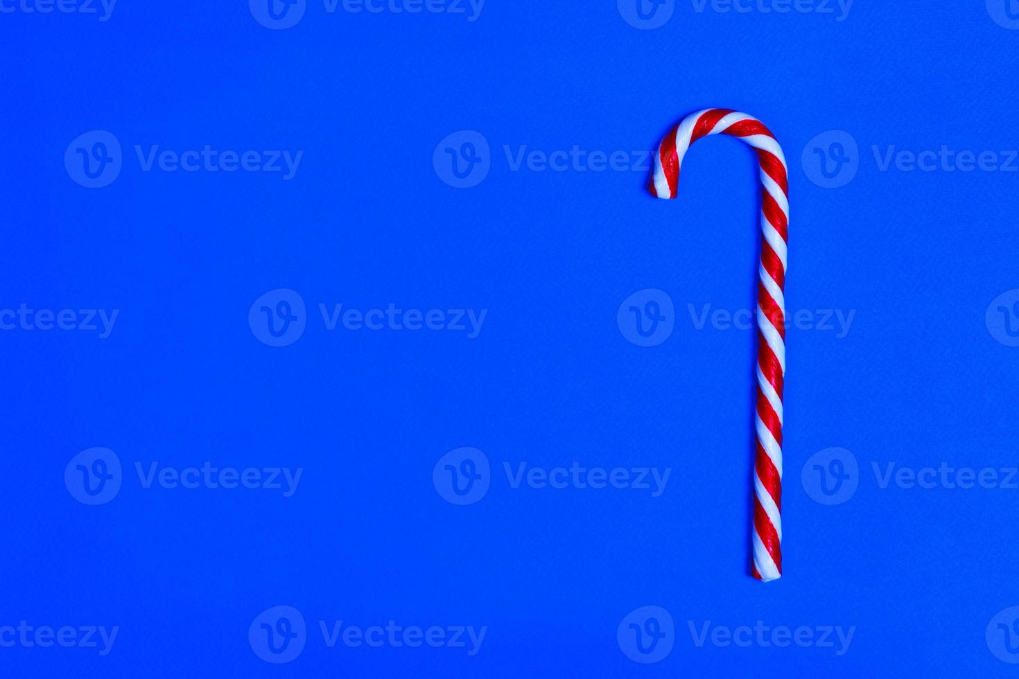 Christmas candy cane on blue background. Flat lay and top view. copy space photo