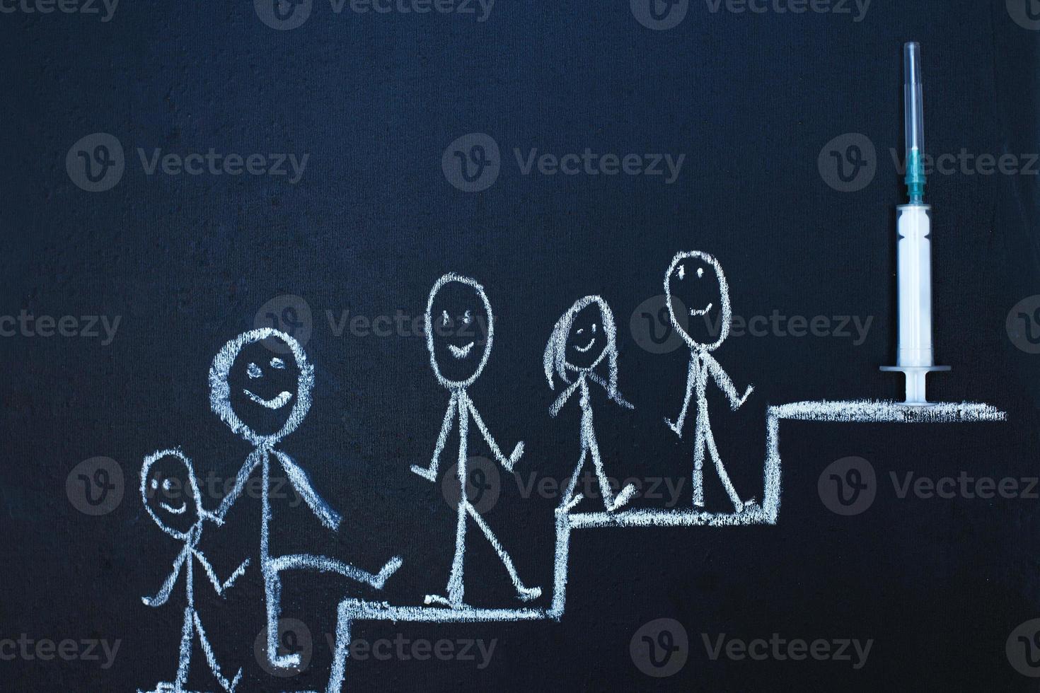 Drawn man on chalk board limbs up stairs tj the syringe vaccine. The queue to receive covid vaccination concept. photo