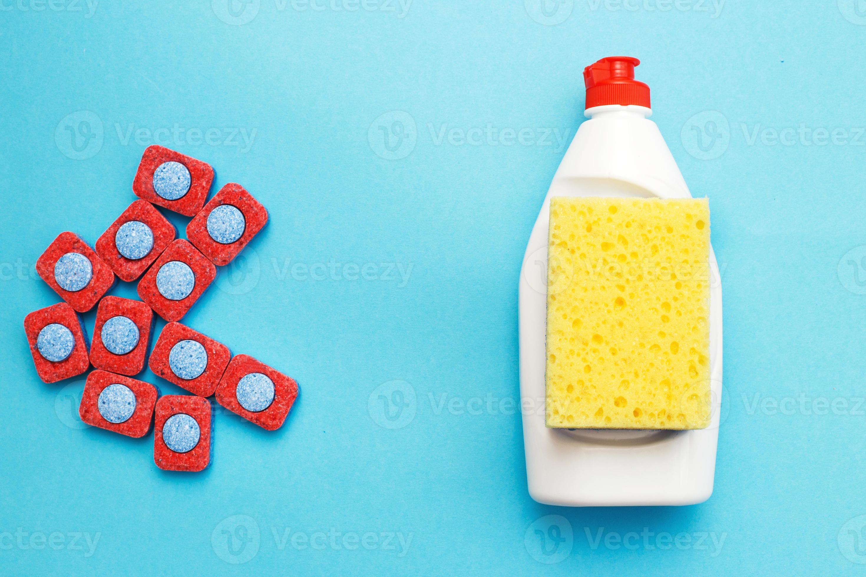 capsules for dishwashers, dishwashing liquid and sponges on a blue