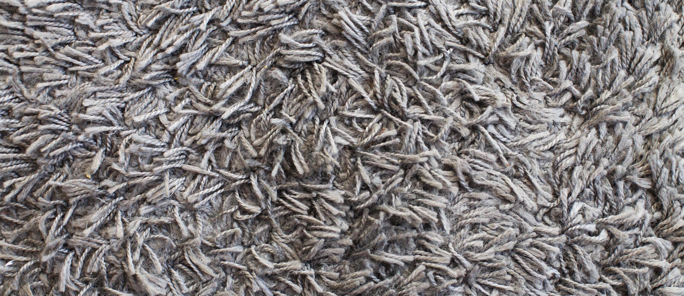la textura de la alfombra gris. fondo de superficie lanuda foto
