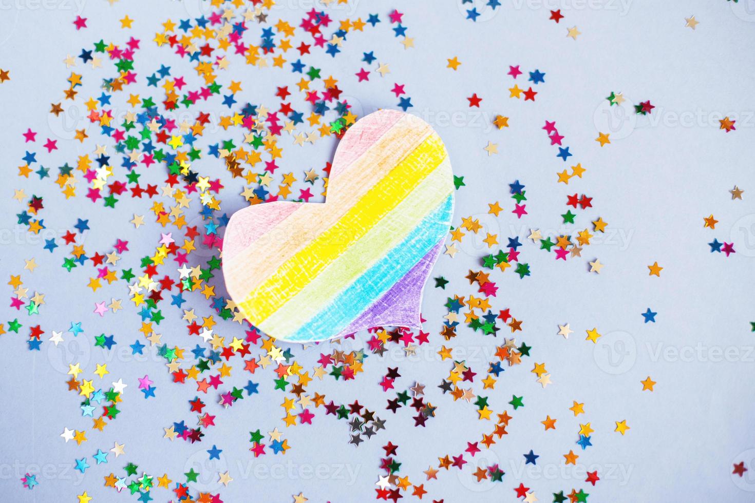 lentejuelas milticolores y bandera lgtb en forma de corazón. concepto de vacaciones lgbt foto