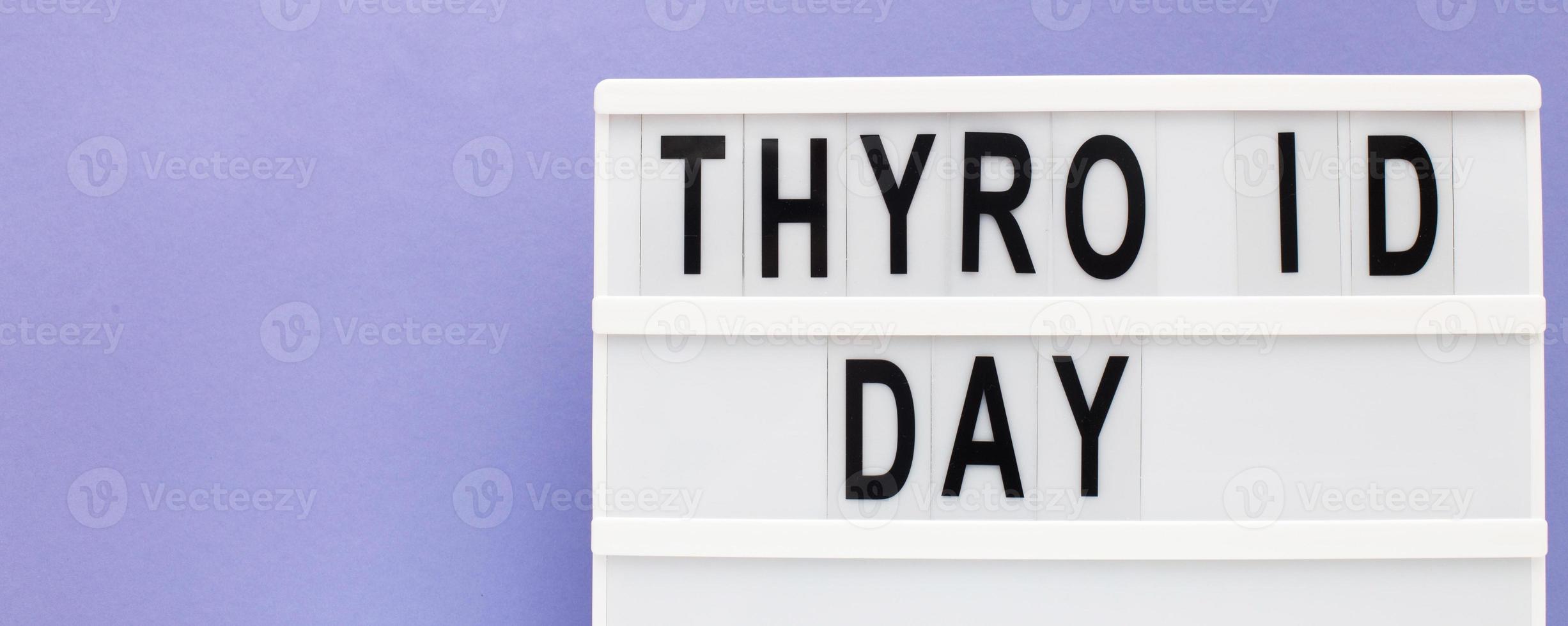 inscription international thyroid day on purple background. copy space. banner photo