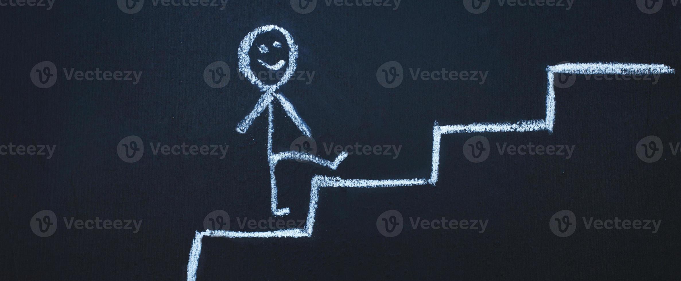 drawn man on the chalk board climbs up step by step to the top of career stairs. copy space . banner photo