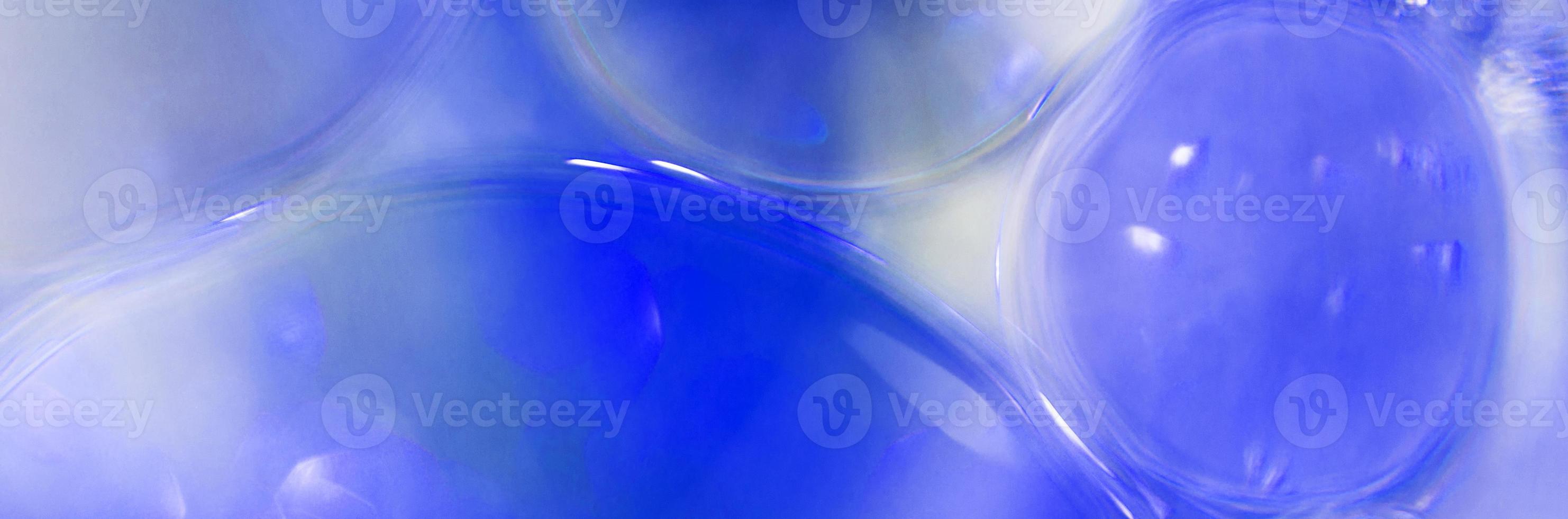 Oil bubbles close up. circles of water macro. abstract light blue background. banner photo