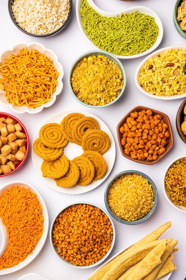 Indian Tea time snacks in group. Sev, chivda, farsan, mixture, bakarwadi served in different bowls photo