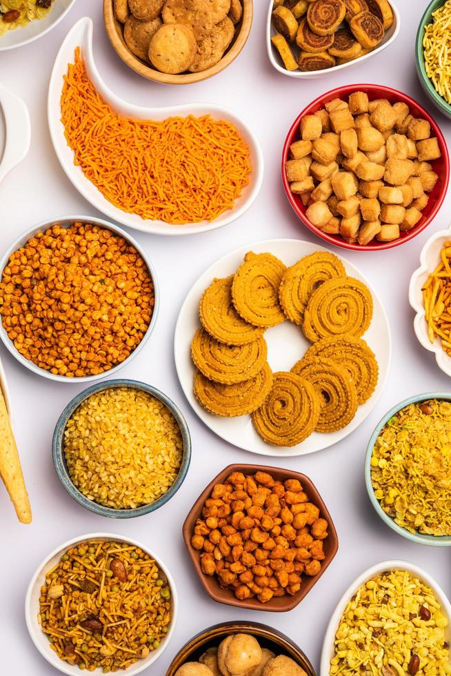 Indian Tea time snacks in group. Sev, chivda, farsan, mixture, bakarwadi served in different bowls photo