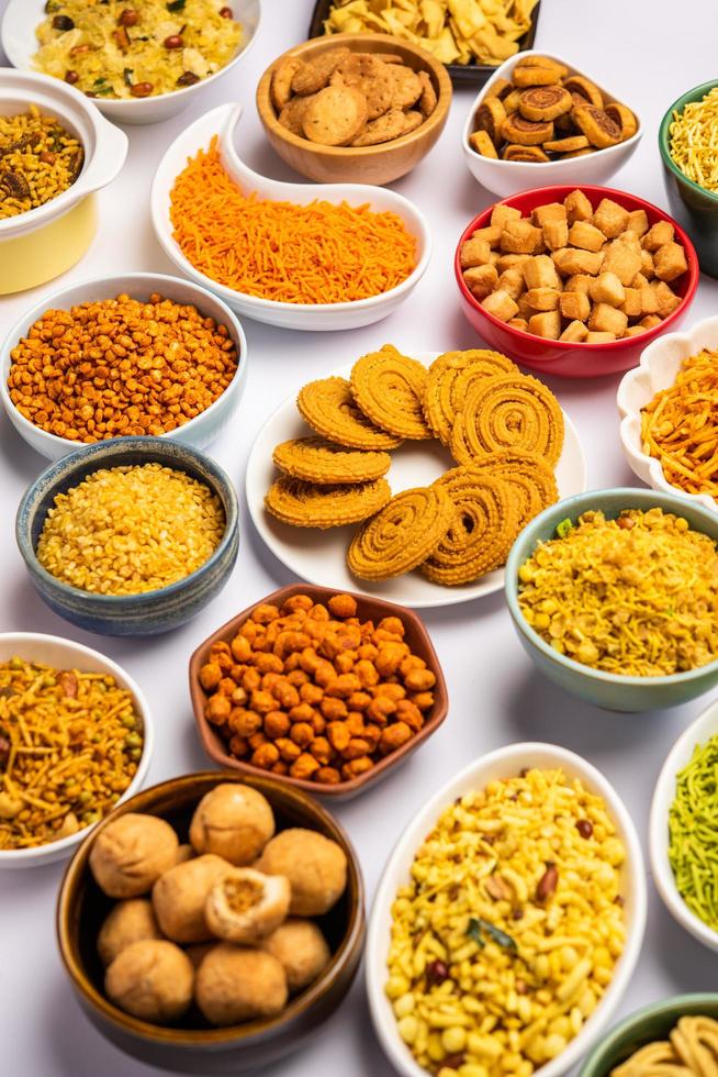 Indian Tea time snacks in group. Sev, chivda, farsan, mixture, bakarwadi served in different bowls photo