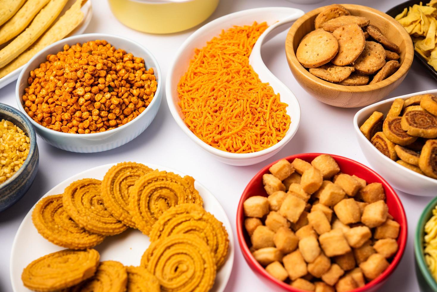 Indian Tea time snacks in group. Sev, chivda, farsan, mixture, bakarwadi served in different bowls photo