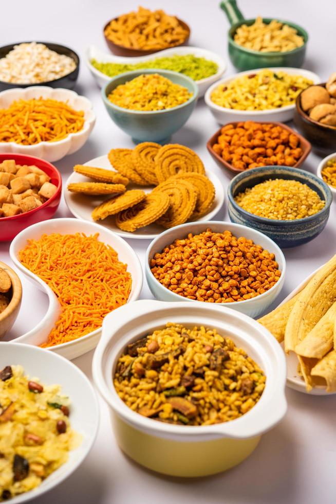 Indian Tea time snacks in group. Sev, chivda, farsan, mixture, bakarwadi served in different bowls photo