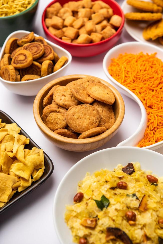 Indian Tea time snacks in group. Sev, chivda, farsan, mixture, bakarwadi served in different bowls photo