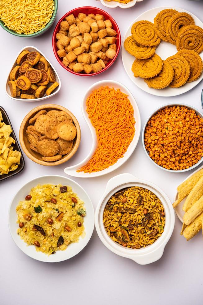 Indian Tea time snacks in group. Sev, chivda, farsan, mixture, bakarwadi served in different bowls photo