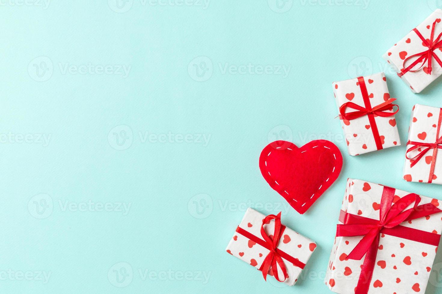 Top view of gift boxes and red textile hearts on colorful background. St Valentine's day concept with copy space photo