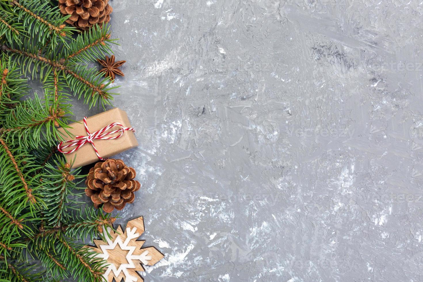 Christmas background with fir tree and gift box on wooden table. Top view with copy space for your design photo