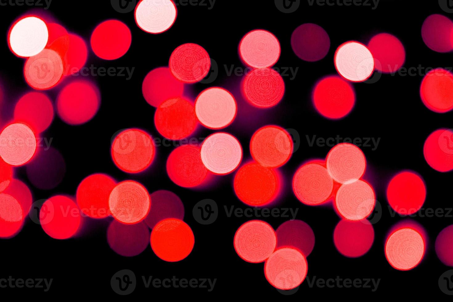 Unfocused abstract red bokeh on black background. defocused and blurred many round light photo