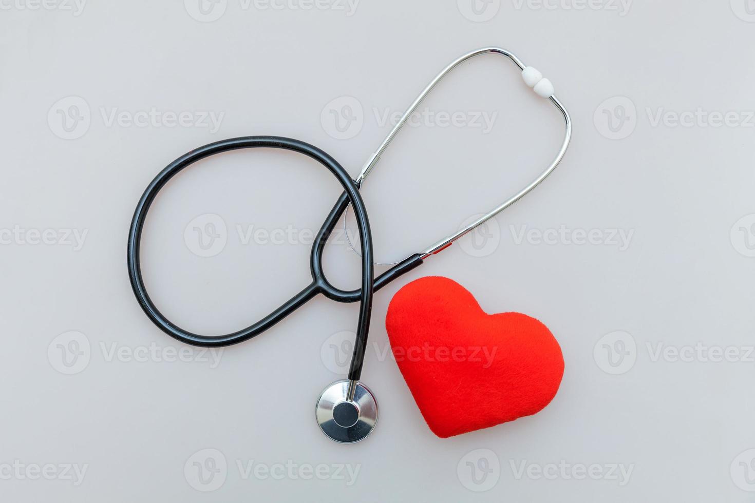 Medicine equipment stethoscope or phonendoscope and red heart isolated on white background. Instrument device for doctor. Health care life insurance concept photo