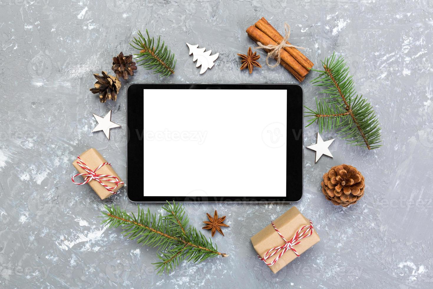 Digital tablet mock up with rustic Christmas gray cement background decorations for app presentation. top view with copy space photo