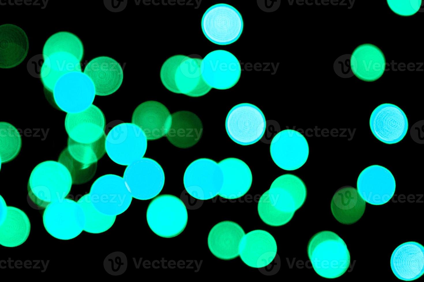Unfocused abstract colourful bokeh black background. defocused and blurred many round blue light photo