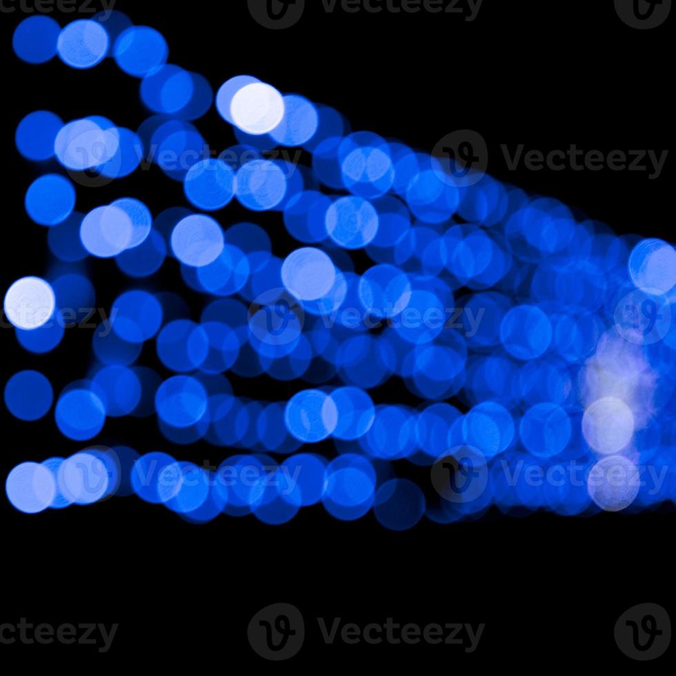 Unfocused abstract colourful bokeh black background. defocused and blurred many round blue light photo