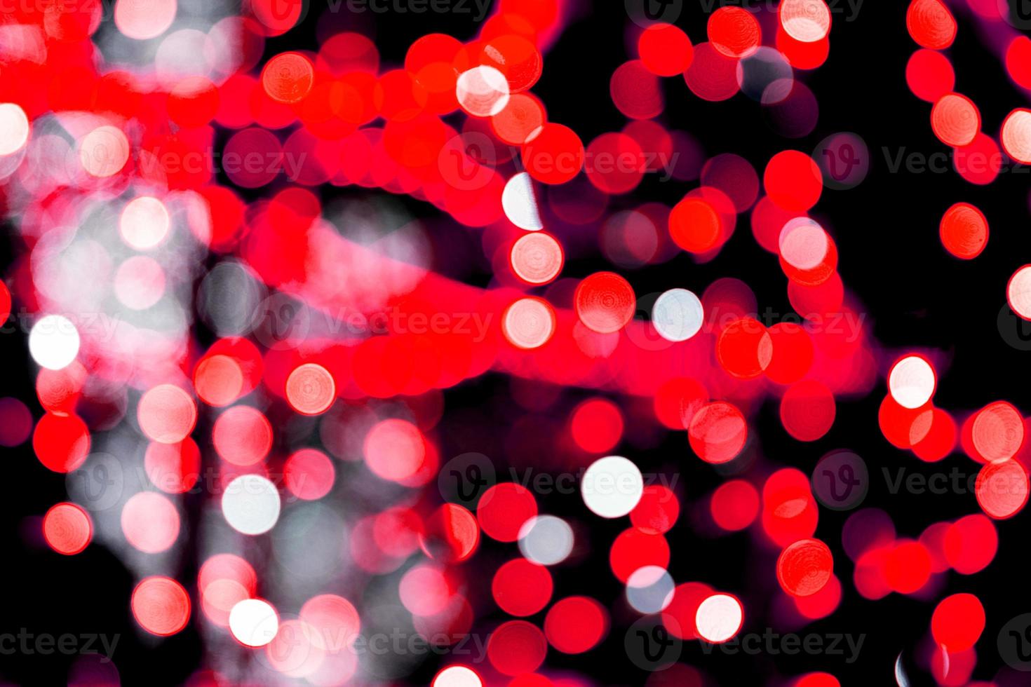 Unfocused abstract red bokeh on black background. defocused and blurred many round light photo