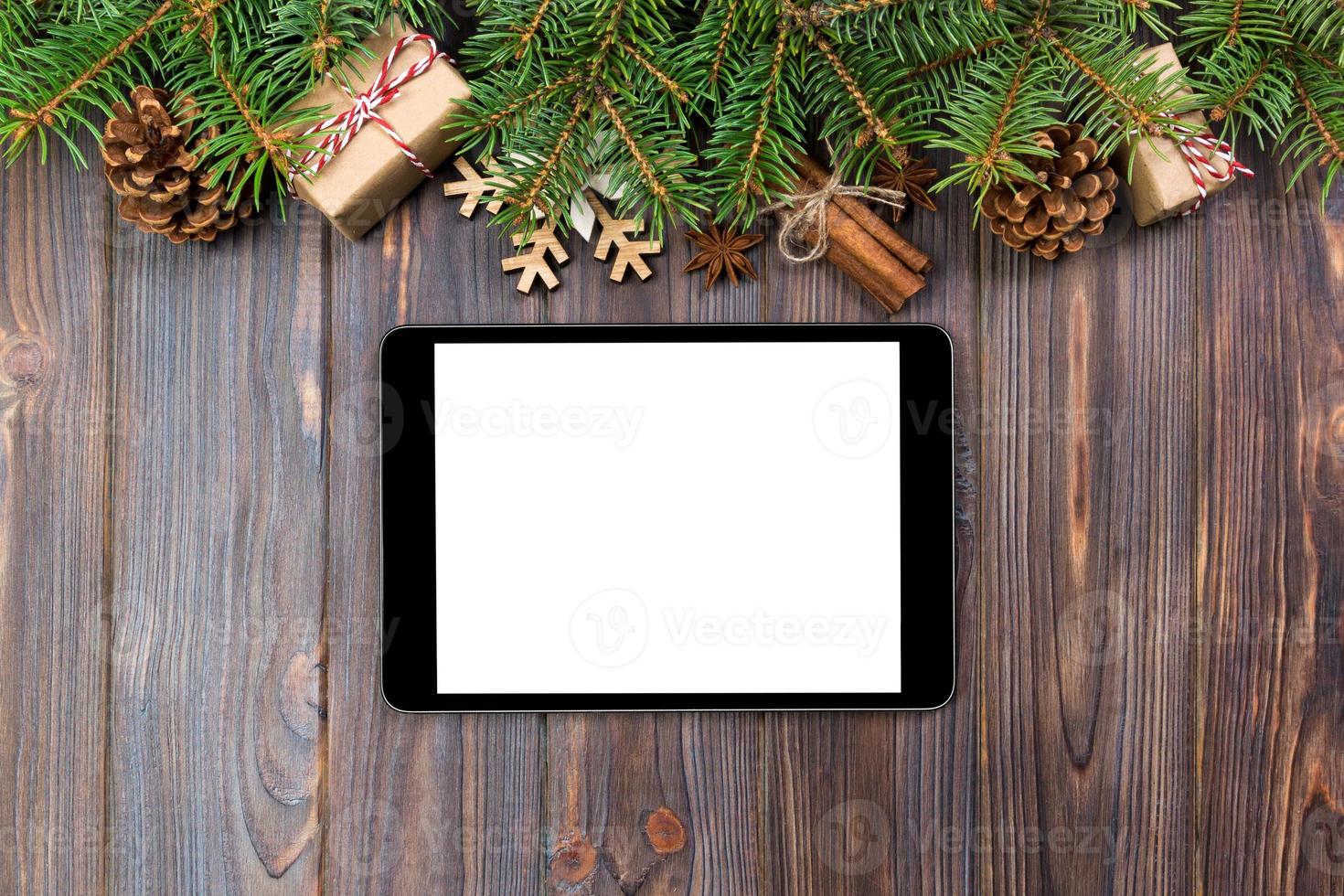 Digital tablet mock up with rustic Christmas wood background decorations for app presentation. top view with copy space photo