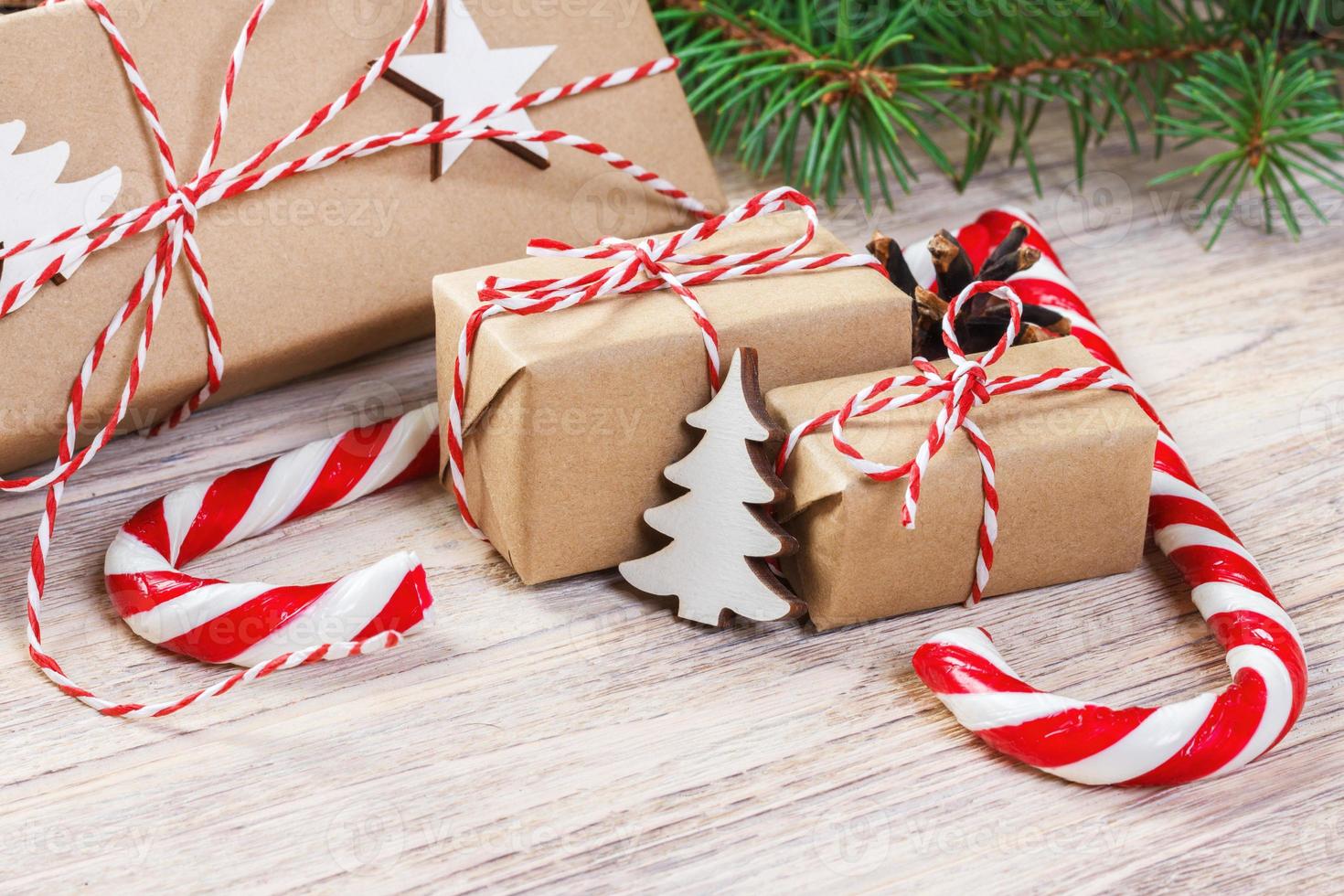 Christmas gifts with Fir tree and decorative cone. Sweets and gifts for holidays. colored candies. Snowflakes. Xmas and Happy New Year composition. Flat lay, top view photo