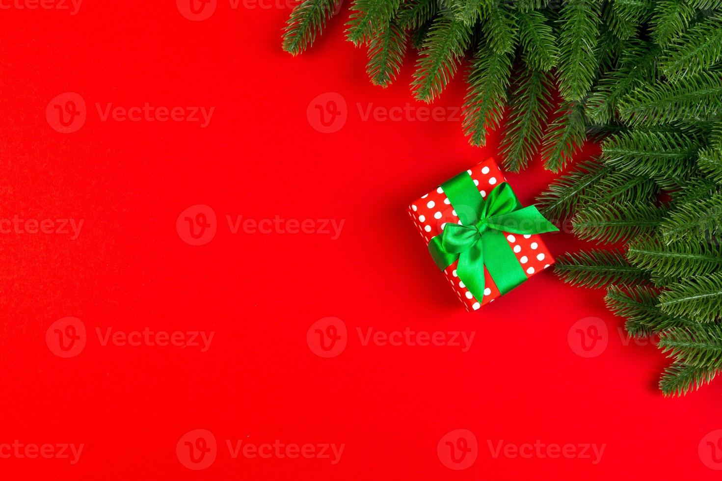 Top view of colorful holiday background made of fir tree and gift box. Happy New Year concept with copy space photo