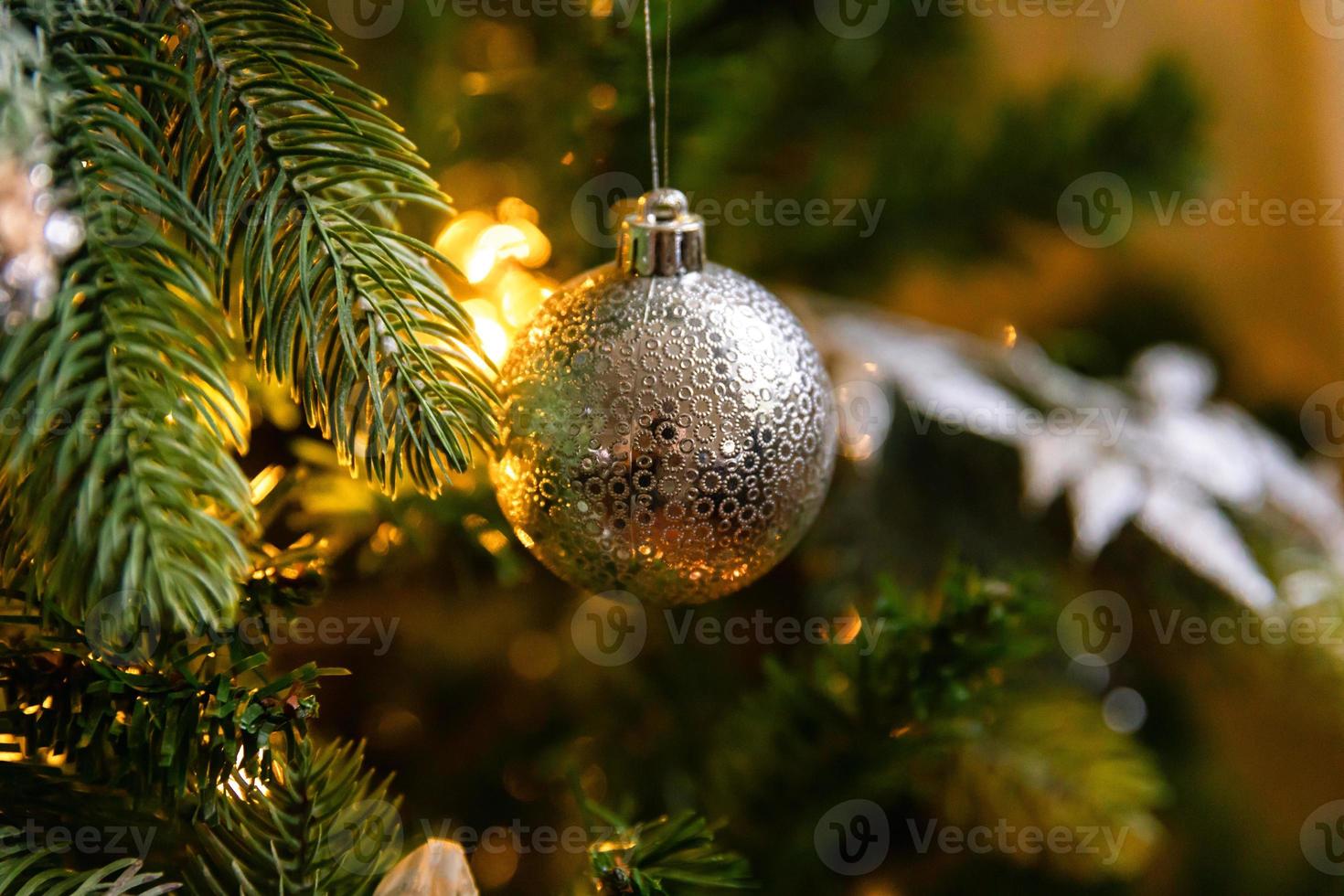 Classic Christmas decorated New year tree. Christmas tree with white and silver decorations, ornaments toy and ball. Modern classical style interior design apartment. Christmas eve at home. photo