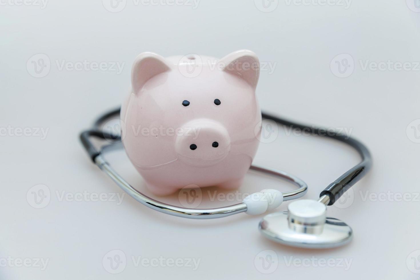 Medicine doctor equipment stethoscope or phonendoscope and piggy bank isolated on white background photo