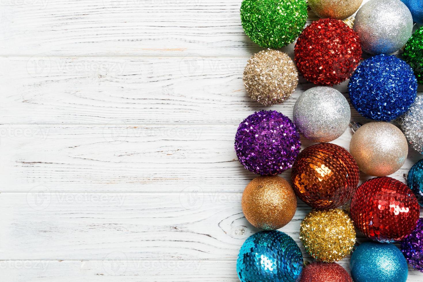 Festive composition of decorative baubles on wooden background. Top view of Christmas toys with copy space photo