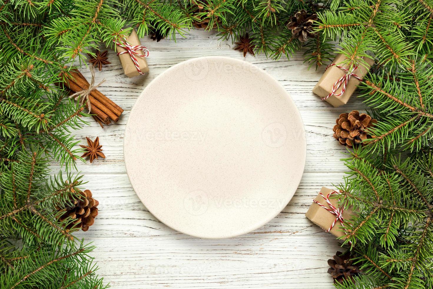 top view. Empty plate round ceramic on wooden christmas background. holiday dinner dish concept with new year decor photo