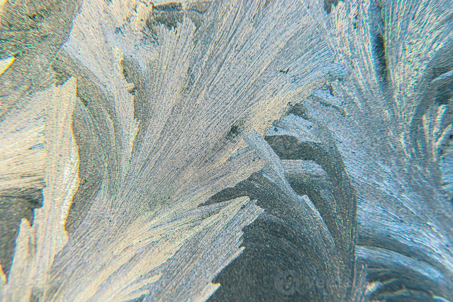 Frozen winter window with shiny ice frost pattern texture. Christmas wonder symbol, abstract background. Extreme north low temperature, natural Ice snow on frosty glass, cool winter weather outdoor. photo
