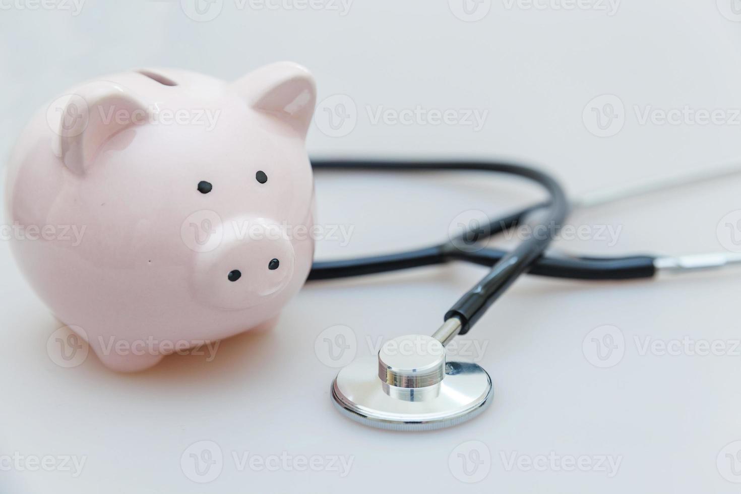 Medicine doctor equipment stethoscope or phonendoscope and piggy bank isolated on white background photo