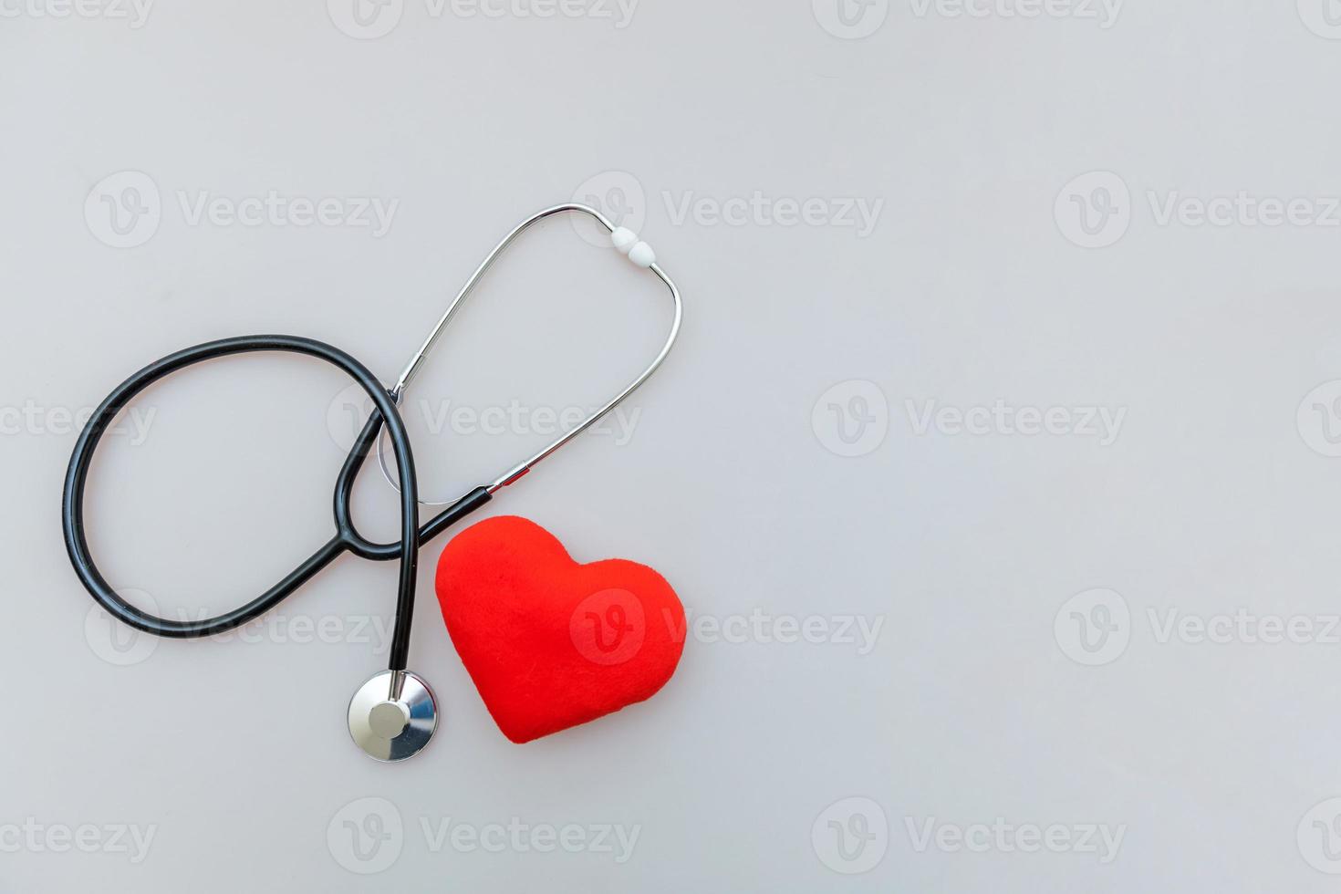 Medicine equipment stethoscope or phonendoscope and red heart isolated on white background. Instrument device for doctor. Health care life insurance concept photo