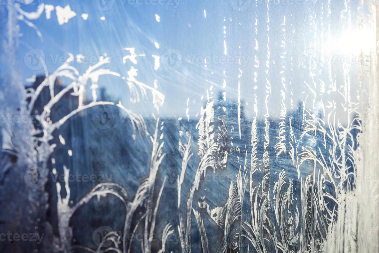 Frozen winter window with shiny ice frost pattern texture photo