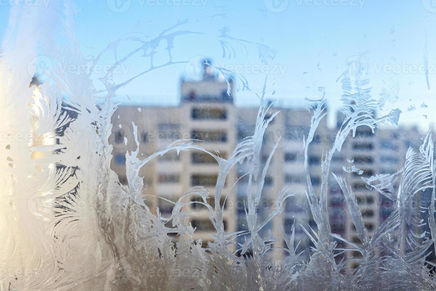 Frozen winter window with shiny ice frost pattern texture photo