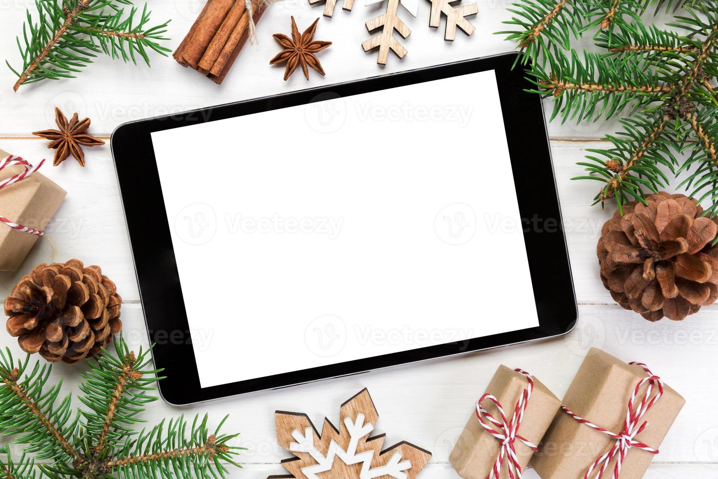 Digital tablet mock up with rustic Christmas wooden background decorations for app presentation. top view with copy space photo