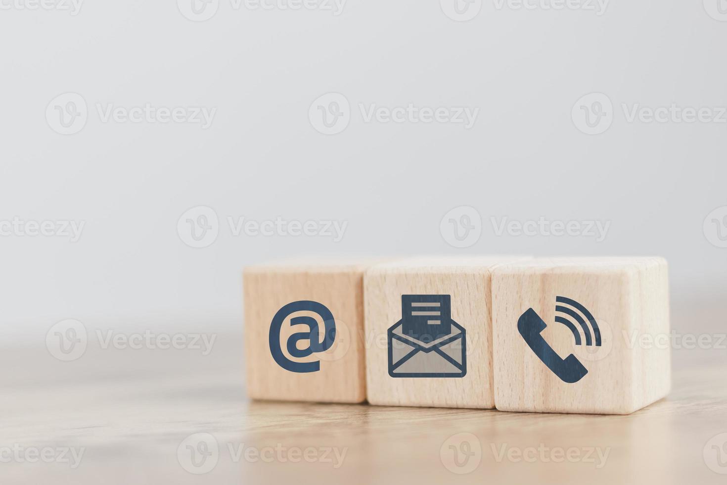 Customer support hotline Contact us concept cube wood showing icons, smartphones, message boxes, addresses and letters, conveys the contact channel. with the service online support for advice photo