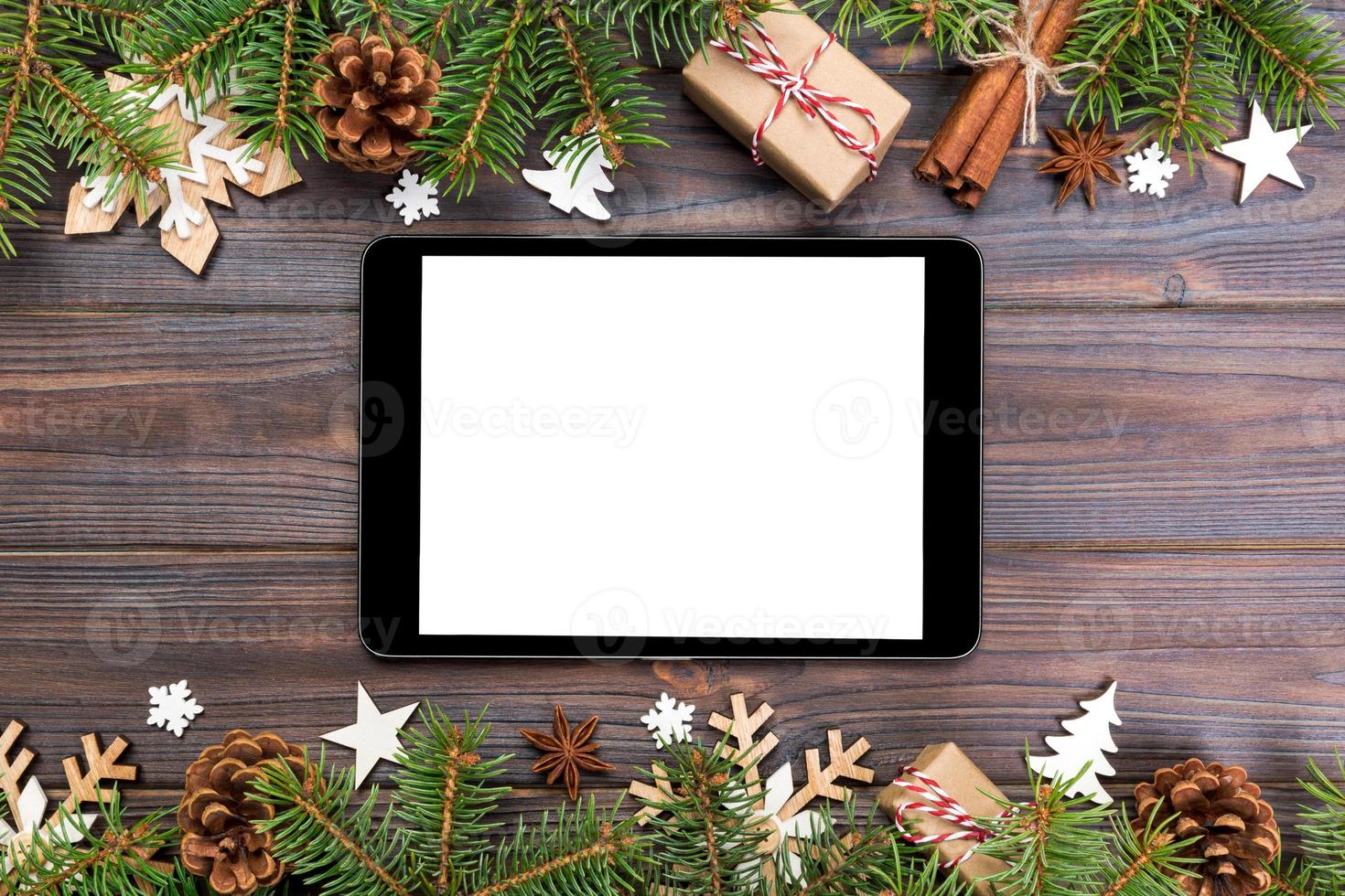 Digital tablet mock up with rustic Christmas wood background decorations for app presentation. top view with copy space photo