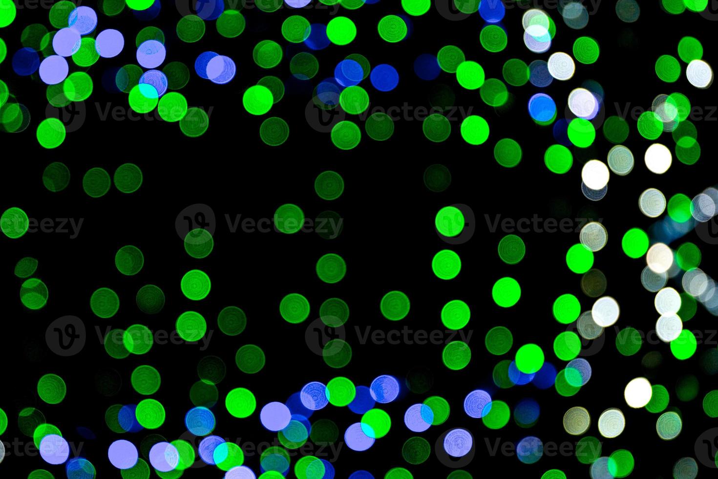 Unfocused abstract colourful bokeh on black background. defocused and blurred many round light photo