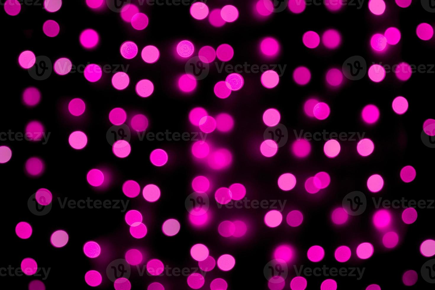 Unfocused abstract colourful bokeh purple background. defocused and blurred many round purple light photo