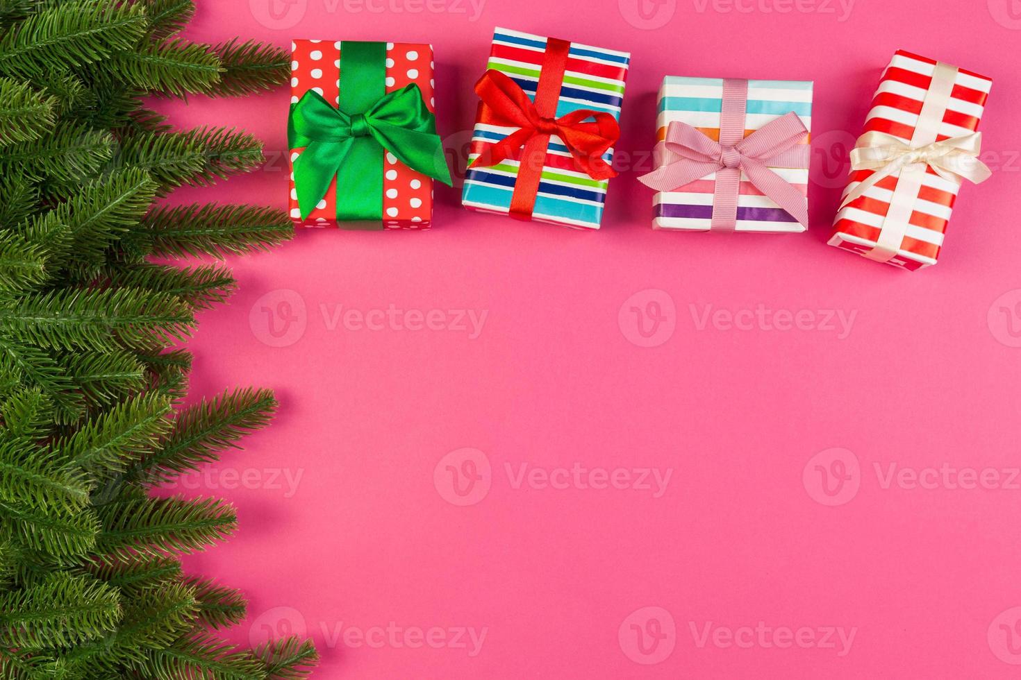 Top view of colorful holiday background made of fir tree and gift box. Happy New Year concept with copy space photo