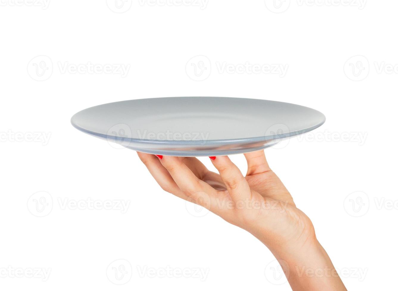 Blank empty round gray matte plate in female hand. perspective view, isolated on white background photo
