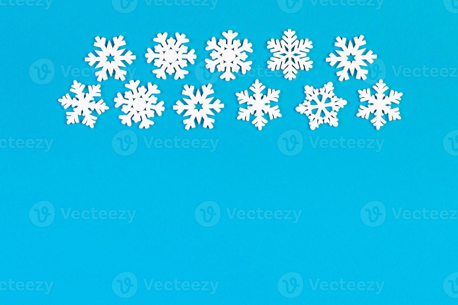 Set of white snowflakes on colorful background. Top view of Christmas ornament. New Year time concept with empty space for your design photo